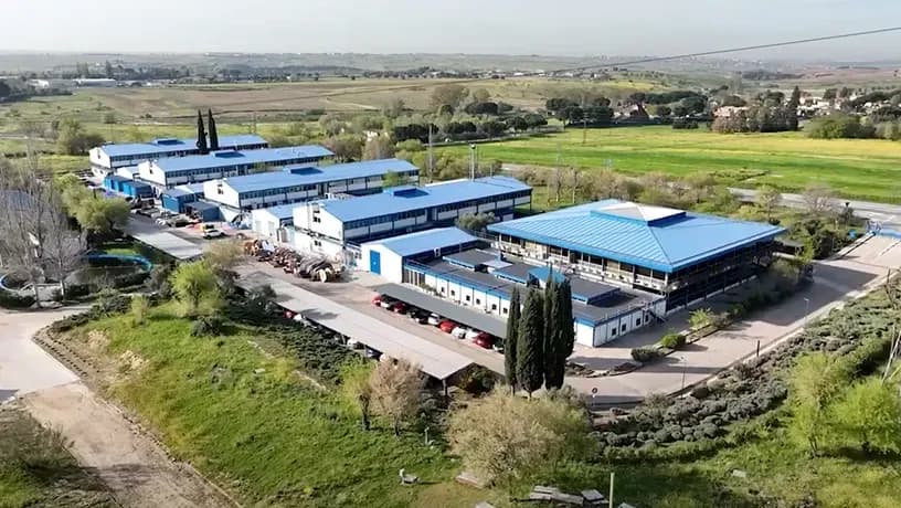 Aerial view of CEISLAB's industrial facilities with multiple blue-roofed buildings.